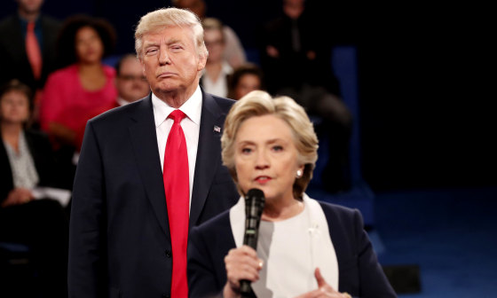 Image:Donald Trump listens as Hillary Clinton answers questions during a debate at Washington University in St. Louis, Missouri, on Oct. 9, 2016.