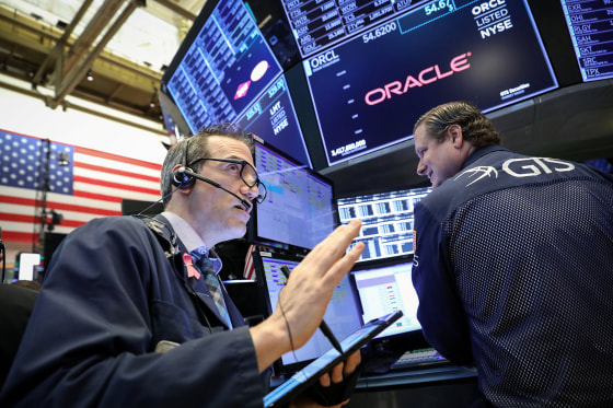 Image: Traders work on the floor at the NYSE in New York
