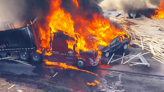 At least two people were killed Thursday in a crash involving three semis and a dozen cars on Interstate 70 near Denver.