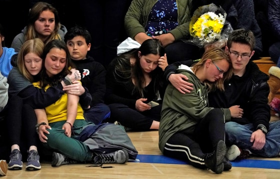 Image: Students hug at a vigil for the victims of the shooting at the Science, Technology, Engineering and Math (STEM) School in Highlands Ranch