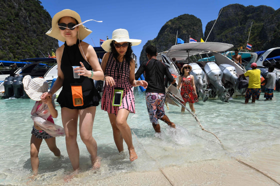 Image: Tourists get off a speedboat onto Maya Bay, on the southern Thai island of Koh Phi Phi