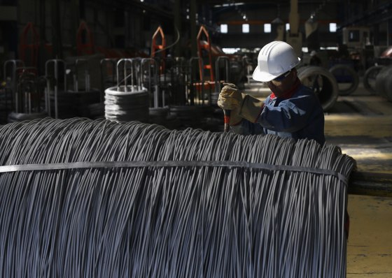 Worker inspects wire rod at TIM stainless steel wire factory in Huamantla