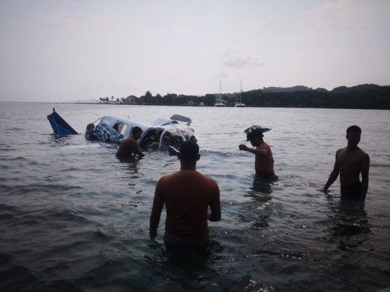 Image: Honduran firefighters at the site of an accident where a light plane crashed into the sea at the Isla Bonita Area, in Roatan, Honduras