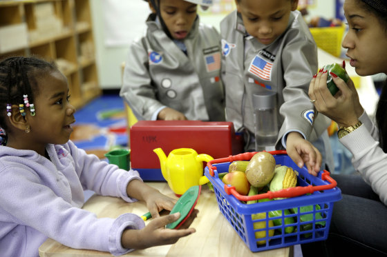 Oumou Balde, 4, left, plays with her teacher Jacqualine Sanchez, right, and pretend food in a pre-kindergarten class at the Sheltering Arms Learning Center in New York in a program to educate children about nutrition and health on, Jan. 21, 2014.