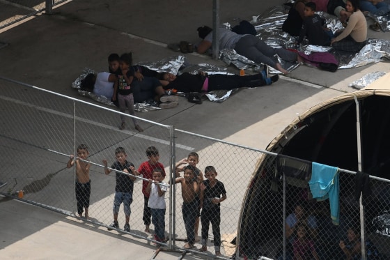 Image: Migrants are seen outside the U.S. Border Patrol McAllen Station in a makeshift encampment in McAllen