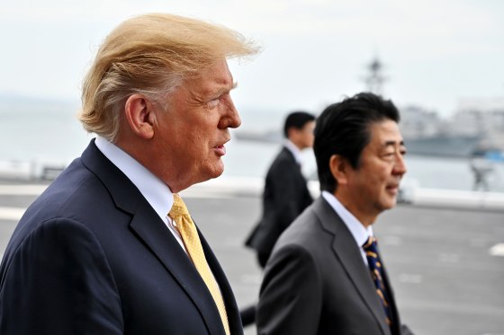 Image: President Donald Trump and Japanese Prime Minister Shinzo Abe walk aboard a helicopter carrier in Yokosuka on May 28, 2019.