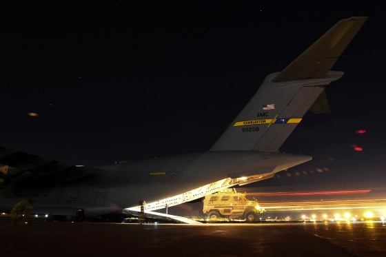 Image: A U.S. Soldier drives a MaxxPro mine-resistant, ambush protected vehicle onto a C-17 Globemaster III assigned to the 816th Expeditionary Airlift Squadron, out of Al Udeid Air Base in Doha