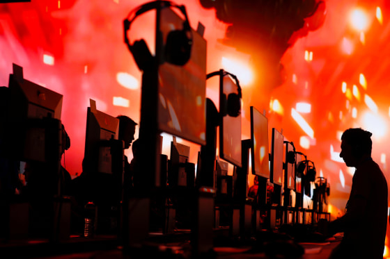 Image: Attendees test out new games during the opening day of E3, the annual video games expo revealing the latest in gaming software and hardware in Los Angeles,