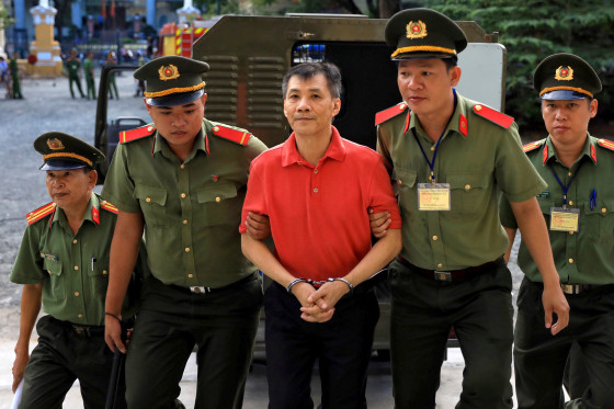 Image: Michael Nguyen is escorted by police to court in Ho Chi Minh City, Vietnam, on June 24, 2019.