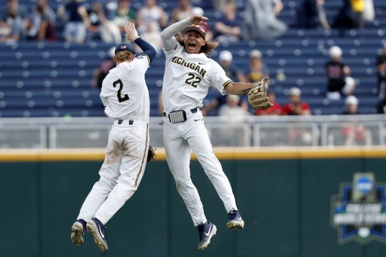 Image: Michigan Wolverines shortstop Jack Blomgren and right fielder Jordan Brewer celebrate after defeating Texas Tech in the College World Series on June 21, 2019.