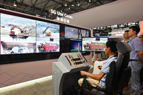 Image: A man tries out a remote control machine with 5G technology at a Huawei stand during the Mobile World Congress introducing next-generation technology at the Shanghai New International Expo Center