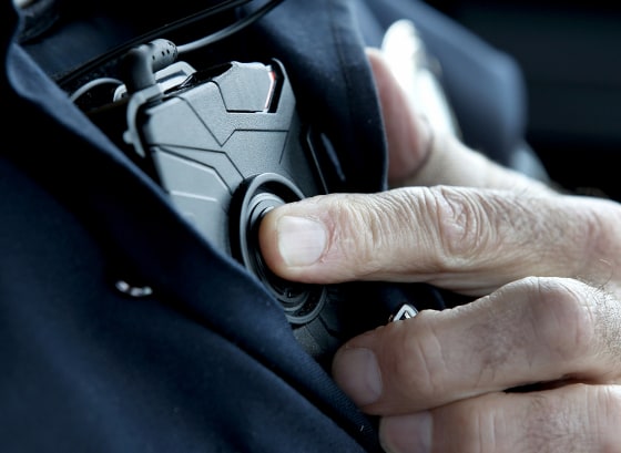 Image: A West Valley City patrol officer starts an Axon body camera in Utah on March 2, 2015.