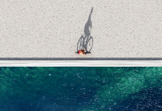 woman ride on bike on summer beach