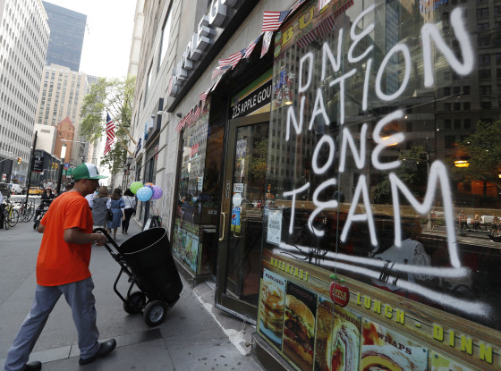 Image: A spray-painted sign honors the four-time World Cup winning U.S. women's soccer team, one day ahead of a ticker-tape parade and City Hall ceremony honoring their latest achievement,