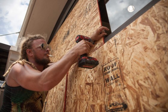 Image: Matt Harrington boards up a Vans shoe store near the French Quarter in New Orleans as tropical storm Barry approaches