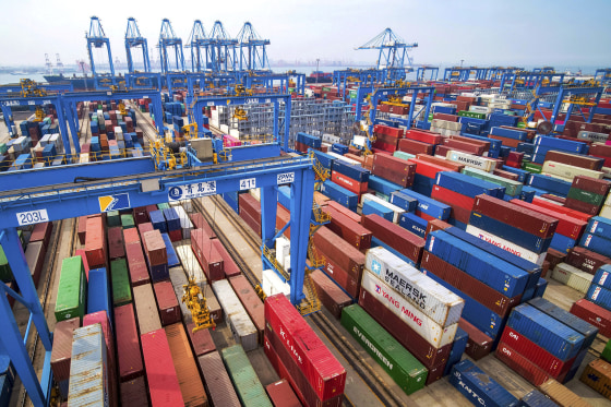 Image: Containers are piled up at a port in Qingdao in east China's Shandong province.