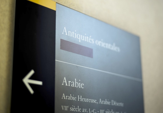 Image: A taped over sign is pictured at the Louvre Museum in Paris, France