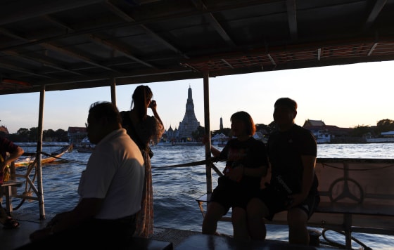 Image: Tourists take pictures of the Wat Arun Buddhist temple as they sail along the Chao Phraya river in Bangkok on Dec. 6, 2018.