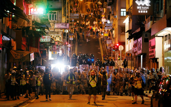 Image: Police officers line up during a protest in Hong Kong on Sunday.