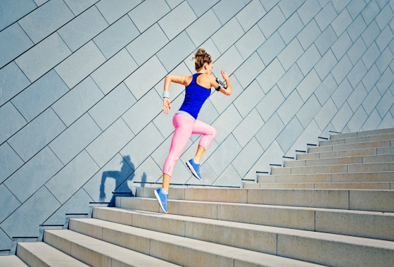 Image: Girl running on the stairs and listening to music