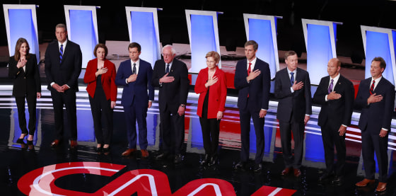 Image: The candidates stand during the national anthem on the first night of the second 2020 Democratic U.S. presidential debate in Detroit