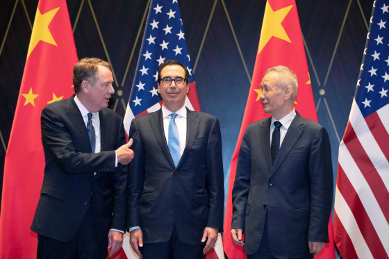 Image: Trade Representative Robert Lighthizer gestures towards Treasury Secretary Steven Mnuchin as he chats with Chinese Vice Premier Liu He before they pose for a family photo at the Xijiao Conference Center in Shanghai,