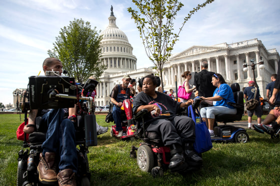 Image: Protesters wait for senators to arrive for a news conference on a health care bill which was part of an effort to repeal the Affordable Care Act in Washington on Sept. 26, 2017.