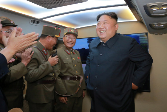 Image: North Korean leader Kim Jong Un smiles as he guides missile testing at an unidentified location in North Korea