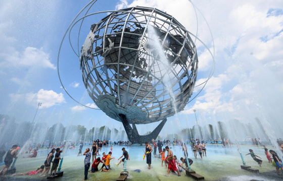 Image: People cool off at the Unisphere fountain at Flushing Meadow Corona Park in the Queens borough of New York during a heatwave on July 21, 2019.