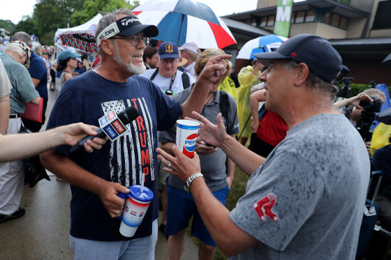 Image: Jim Tangeman, left, a supporter of Donald Trump, debates a critic of the president at the Des Moines Register Political Soapbox during the Iowa State Fair