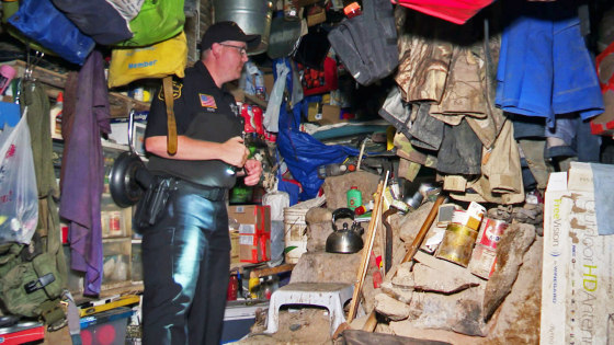 Authorities investigate a makeshift bunker in the township of Ringle, Wis.