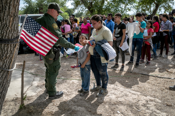 Image: A Border Patrol agent speaks to migrants before they were transferred to a McAllen, Texas, processing center in Los Ebanos on July 2, 2019.