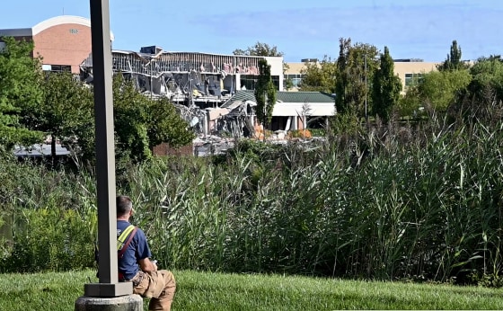 Image: An emergency responder looks at the damage from an explosion at the Lakeside Office Park in Columbia, Md., on Aug. 25, 2019.