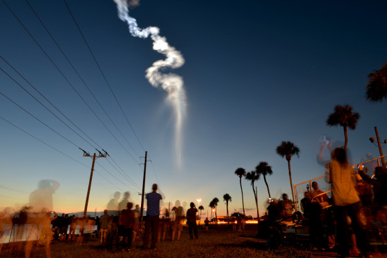 Image: People watch the Atlas V rocket launch at Cape Canaveral Air Force Station in Fla., on Aug. 8, 2019. Atlas V carries an Advanced Extremely High Frequency communications satellite for the Air Force Space and Missile Systems Center.