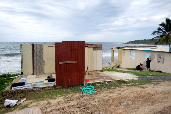Image: A couple boards up their beachfront house as Tropical Storm Dorian approaches Yabucoa, Puerto Rico, on Aug. 28, 2019.
