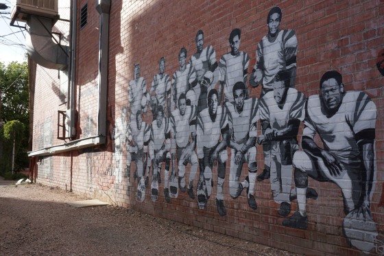 Image: Part of an alleyway mural in downtown Laramie, Wyo., that honors the Black 14