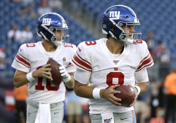 Image: New York Giants quarterbacks Eli Manning, left, and Daniel Jones warm up in Foxborough, Mass., on Aug. 29, 2019.