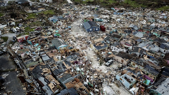 Image: People walk through a neighbor destroyed by Hurricane Dorian at Marsh Harbour in Great Abaco Island, Bahamas