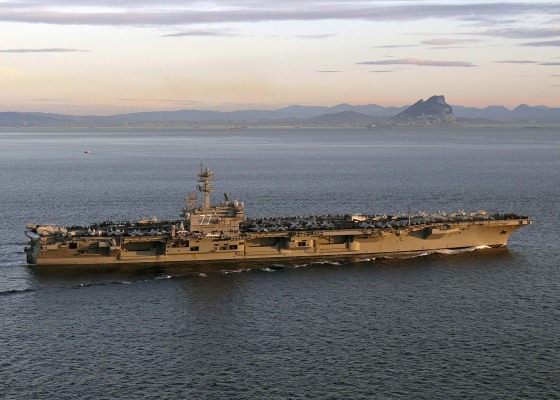 Image: The aircraft carrier USS George H.W. Bush transiting the Strait of Gibraltar into the Mediterranean Sea