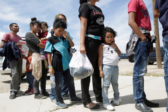 Image: Central American migrants stand in line before entering a temporary shelter, after illegally crossing the border between Mexico and the U.S., in Deming