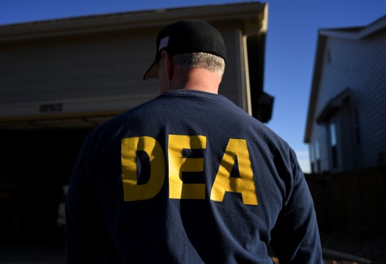Image: A Drug Enforcement Administration officer during a home raid in Colorado on Jan. 31, 2019.