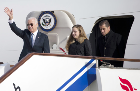 U.S. Vice President Biden waves as he walks out of Air Force Two with his granddaughter Biden and son Biden at the airport in Beijing