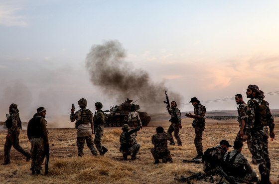Image: Turkish soldiers and Turkish-backed Syrian fighters gather on the outskirts of Manbij on Oct. 14, 2019.