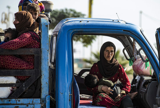 Image: Syrian families fleeing the battle zone between Turkey-led forces and Kurdish fighters from the Syrian Democratic Forces (SDF) in and around the northern flashpoint town of Ras al-Ain, arrive in the city of Tal Tamr