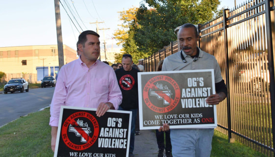 Anti-violence advocate Clifford Ryans, right, walks with Syracuse Mayor Ben Walsh during a demonstration.