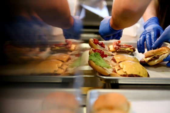 Image: Workers prepare hamburgers at a Shake Shack in Moscow in 2013.