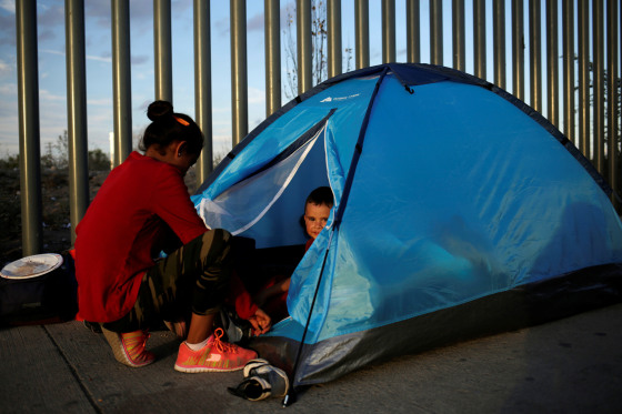 Image: A Mexican citizen fleeing violence camps in a queue with a child to try to cross into the U.S. to apply for asylum at Cordova-Americas border crossing bridge in Ciudad Juarez