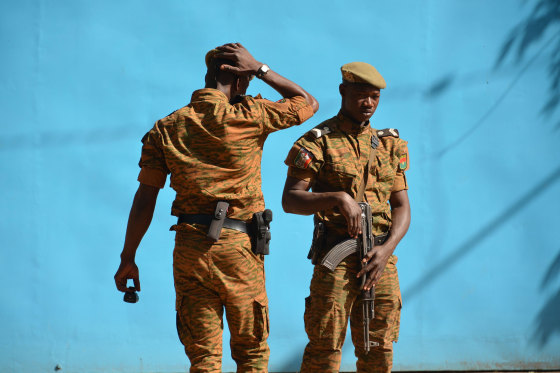 Image: Burkinabe men patrol the army's headquarters from the roof in Ouagadougou, Burkina Faso.