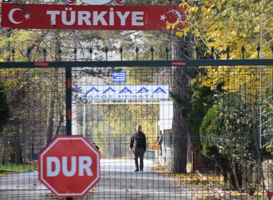 Image: A man, a U.S. citizen of Arab descent and Islamic State suspect who was deported by Turkey, stands on the no-man's land between Turkey and Greece, as he is pictured from the Pazarkule border crossing near Edirne