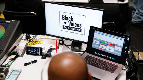 Image: U.S. President Donald Trump is seen broadcasted live on a phone as he speaks at his Black Voices for Trump Coalition rollout event in Atlanta